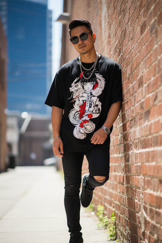 Man wearing a black t-shirt with a graphic design, sunglasses, and ripped jeans leaning against a brick wall.